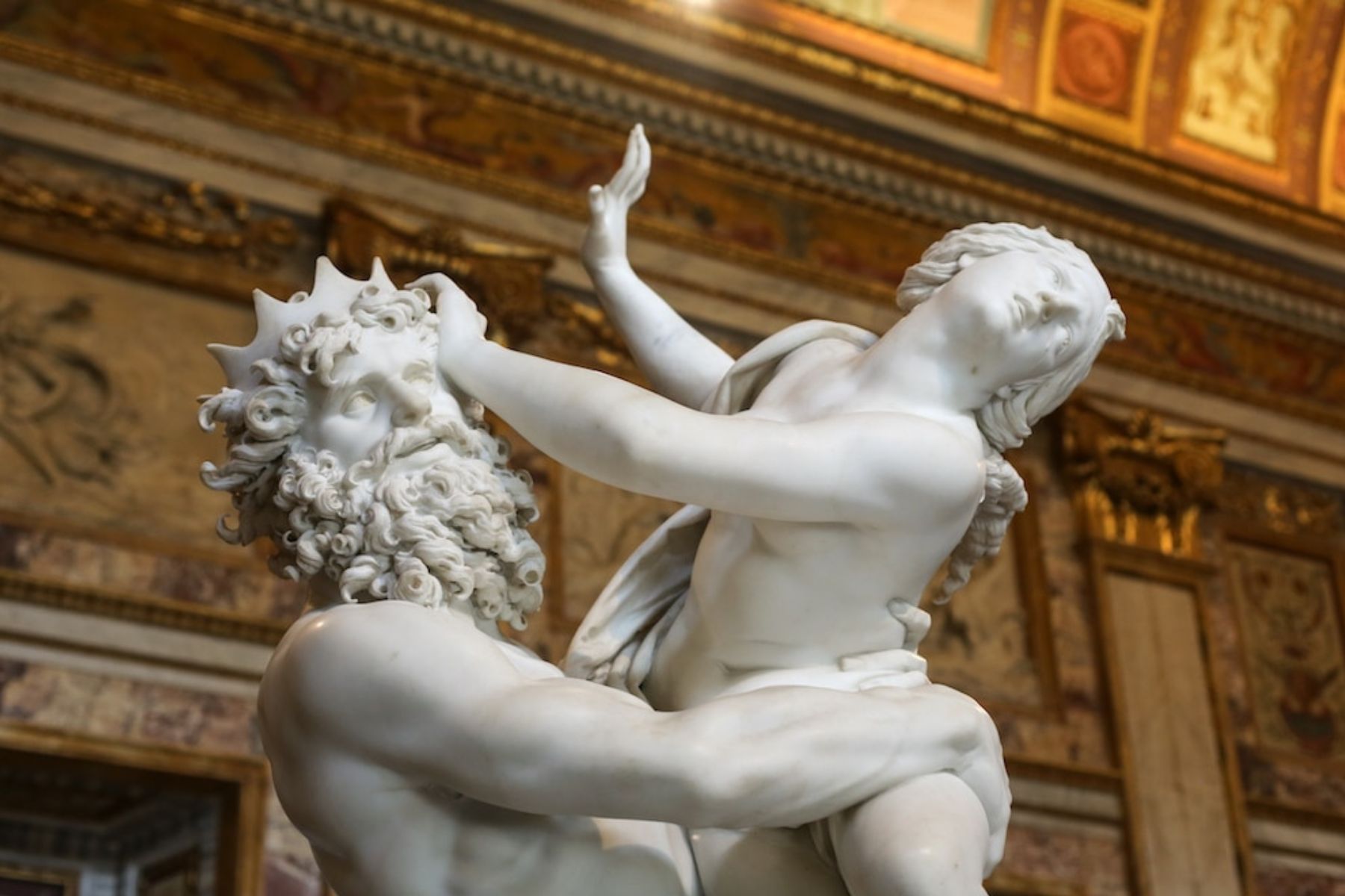 Close-up of Pluto’s hand gripping Proserpina’s thigh in Bernini’s marble sculpture